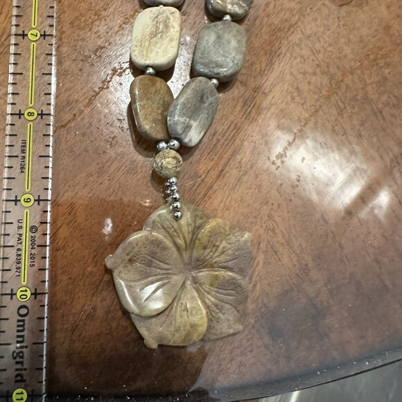 This necklace is a chunky, natural stone necklace with a carved flower pendant - Picture 5 of 10